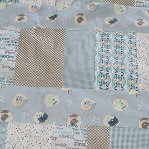 Homemade blue themed quilted baby blanket back is grey fleece.
